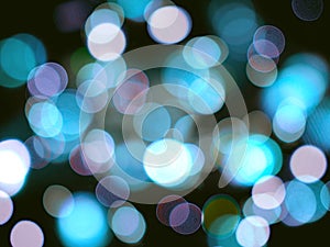 blue and violet bright glowing blurred lights abstract on a black night background