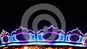 Blue violet Christmas lights on Christkindlmarkt at german Christmas market shows shiny lights in vibrant colors at night with bla