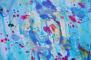 Blue violet pink sparkling spots paint background and wax