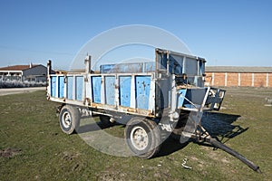 Blue wagon for the transport of grain and straw used intensively in a farm photo