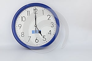 Blue wall clock stopped at 5