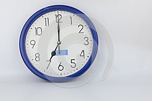 Blue wall clock stopped at 7