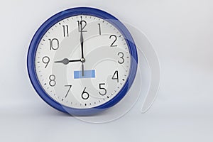 Blue wall clock stopped at 9