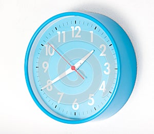 A blue wall clocks on white ground