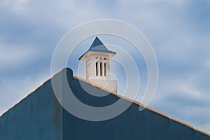 Blue wall house and a chimney