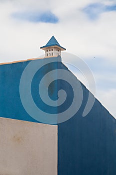 Blue wall house and a chimney