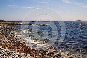 The blue water of the Atlantic ocean at the Louisbourg lighthouse