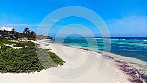 Blue water beach with sea and trees in the background