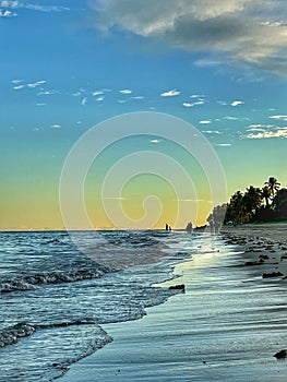 Blue water on beach, sunset hour photo