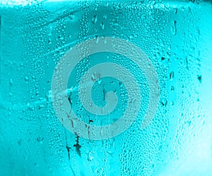 Blue water drop from cold water in plastic bottle