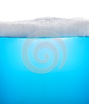 Blue water with foam or soap