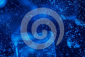 Blue water with ice cubes and bubbles