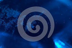 Blue water with ice cubes and bubbles