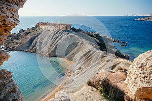 Blue water of Mediterranian sea. Scene of rocky cliff over sunny coastline on Malta