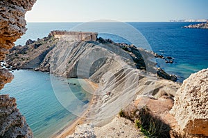 Blue water of Mediterranian sea. Scene of rocky cliff over sunny coastline on Malta photo