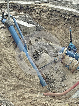 Blue water pipes and shut-off valve on pipe with branch