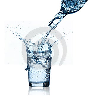Blue water splashing on glass, white background.