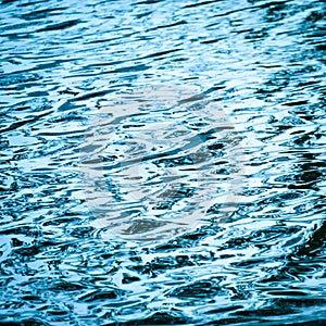 Blue water surface background texture blurred light with wave ri