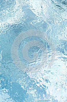 Blue water surface with waves and bubbles. minimalistic fresh summer background for invitation or banner