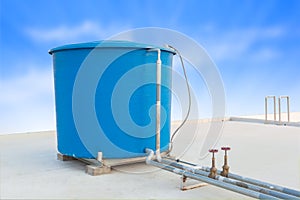 Blue water tank of industrial building on roof top and blue cloud sky background