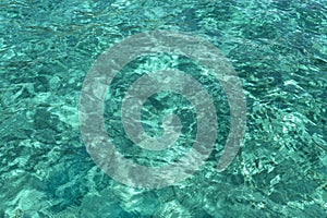 Blue water texture, with ripples and sun reflections