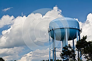 Blue water tower under cloudy skies