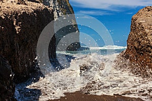 Blue Water Waves Crashing on Black Rocks at Santa Barbara Beach. San Miguel Island, Portugal