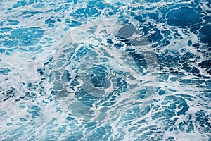 Blue water waves and white spindrift in the sea photo