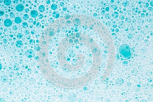 Blue water with white bubbles.Cleanliness and hygiene background. Foam Water Soap Suds.Texture Foam Close-up. blue soap