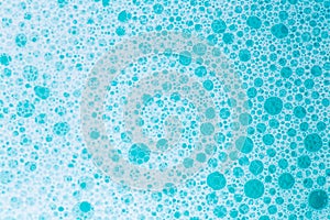 Blue water with white foam bubbles.Cleanliness and hygiene.blue soap bubbles background. Foam Water Soap Suds.Texture