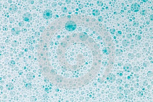 .Blue water with white foam bubbles.Cleanliness and hygiene background.foam bubbles. Foam Soap Suds.Texture Foam Close