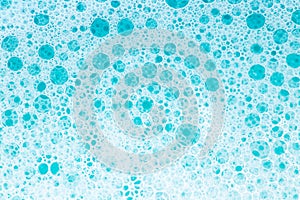 Blue water with white foam bubbles.Cleanliness and hygiene background. Foam Water Soap Suds.Texture Foam Close-up. blue