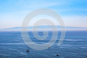 Blue water with yachts as a background from drone. Summer seascape.