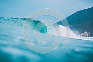 Blue wave in ocean. Surfing swell and cloudy sky