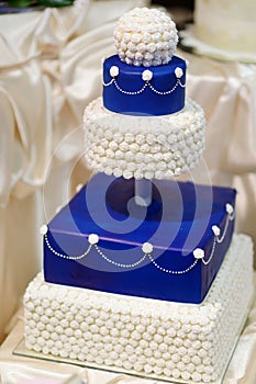 Blue wedding cake decorated with flowers