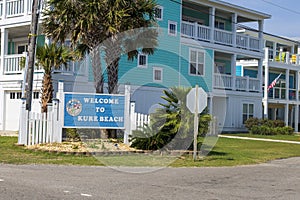 A blue welcome sign that says Welcome to Kure Beach