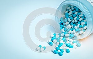 Blue-white antibiotic capsule pill and capsule pills bottle. Antibiotic drug resistance. Pharmaceutics concept. Pharmaceutical