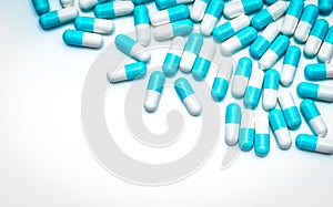 Blue-white antibiotic capsule pills on white background. Colorful capsule pills for healthcare topic. Pharmaceutical industry.