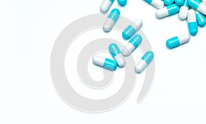 Blue-white antibiotic capsule pills on white background. Colorful capsule pills for healthcare topic. Pharmaceutical industry.