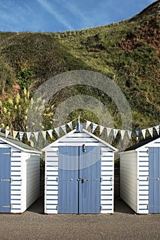 Blue and White Beach Huts at Seaton, Devon, UK.