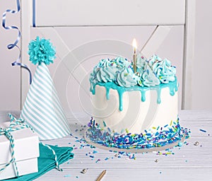 Blue and white Birthday party with cake, gifts and hat over white background.