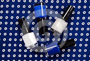 Blue and white bottles of nail polish.