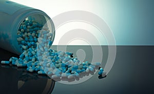 Blue and white capsule pill spilled out from white plastic bottle container. Global healthcare concept. Antibiotics drug