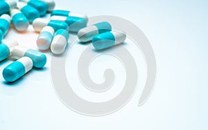 Blue-white capsule pills on white background. Antibiotic drug resistance concept. Capsule pills sampling in pharmaceutical