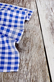 Blue-white checkered tablecloth in an old wooden