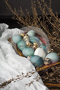 Blue, and white and chicken eggs and quail eggs in wooden retro