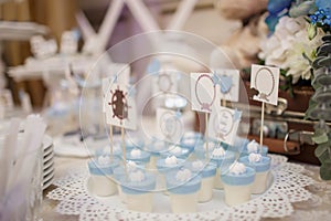 blue and white christening candy bar: close up photo of pana cotta with sticks photo