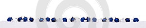 Blue and white Christmas balls in a row isolated on snow