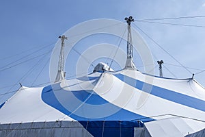 blue and white circus tent under sunny sky