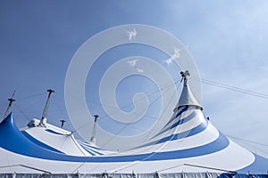 blue and white circus tent under sunny sky